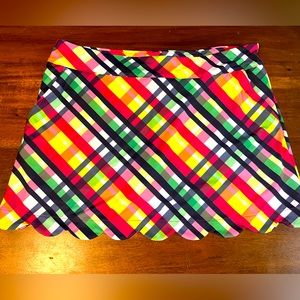 Lillie green athletic skirt, vibrant colors and scalloped hem.